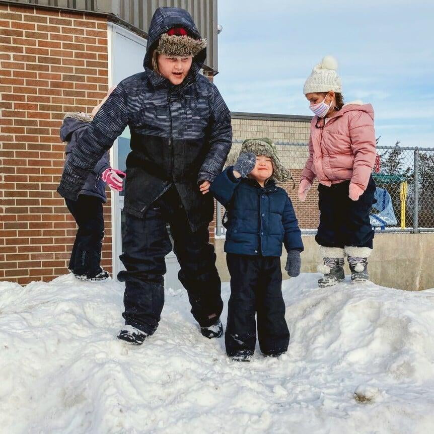 Brothers playing in the snow.